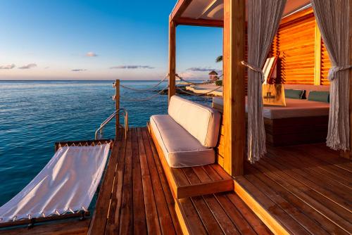 a deck of a boat with a bed on the water at Presidente InterContinental Cozumel Resort & Spa, an IHG Hotel in Cozumel