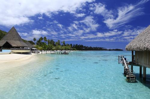 a view of a beach with a resort and the ocean at Sofitel Kia Ora Moorea Beach Resort in Maharepa