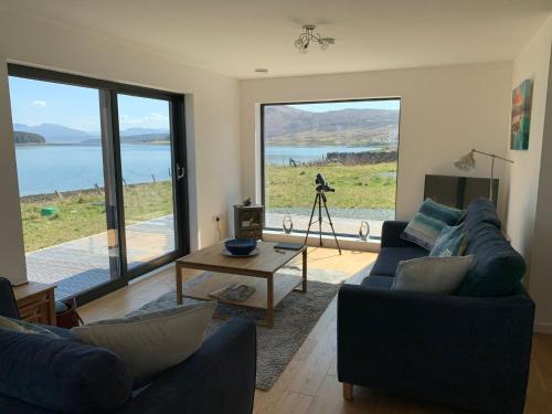 a living room with two couches and a view of the water at Beautiful views from right above the water in Dunan