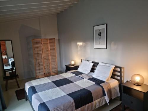 a bedroom with a bed with two tables and two lamps at Place of Moments Natur-Suites SPA in Vila Franca do Campo