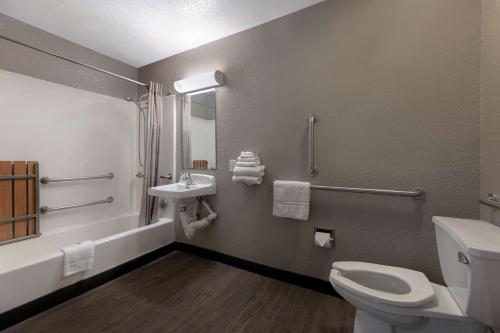 a bathroom with a toilet and a sink at Motel 6-San Antonio, TX - West SeaWorld in San Antonio