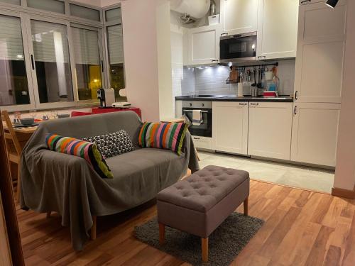 a living room with a couch and a kitchen at BestHomeStay- Parede Beach (Lisbon) in Parede