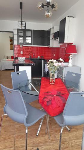 a kitchen with a table and chairs with flowers on it at Casablanca 2 in Tacna