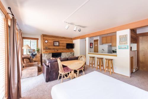 a living room with a table and a kitchen at Granlibakken Tahoe in Tahoe City