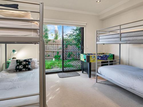 a bedroom with two bunk beds and a window at Starfish Sands in Cowes