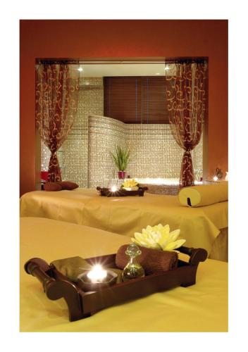 a hotel room with two beds and a tray of food at Diplomat Plaza Hotel & Resort in Lukovit