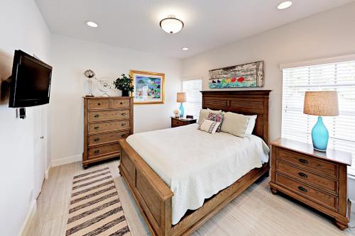 a bedroom with a bed and a flat screen tv at Pompano Retreat in Pompano Beach