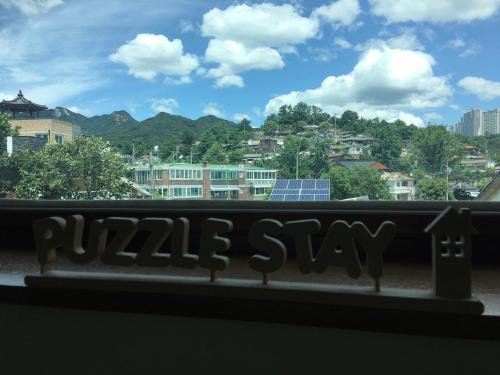a view of a city from a window at Puzzlestay House in Seoul