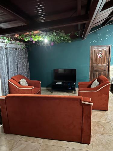 sala de estar con 2 sillas y TV en Bambito´s Café & Hostel en Cerro Punta