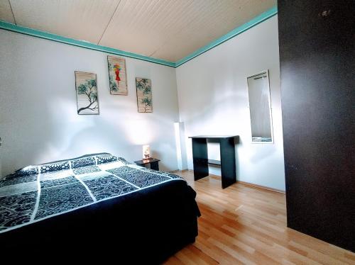 a bedroom with a bed and a table in it at HOSTAL ROMA in Mexico City