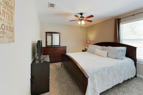 a bedroom with a bed and a ceiling fan at Explore The World in Navarre