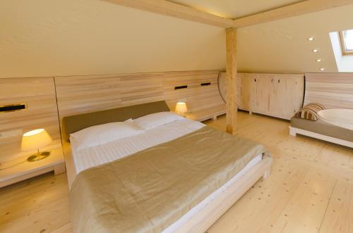 a bedroom with a large bed in a room at Hata Hutsula in Mykulychyn