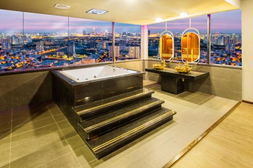 a bathroom with a tub and a view of a city at EROS HOTEL 2 - Love Hotel in Ho Chi Minh City