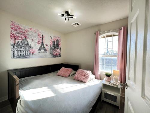 a bedroom with a bed with pink pillows on it at HOMEY PARIS - NEW / Free garage parking / Downtown Salt Lake City in Salt Lake City