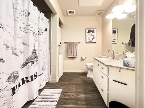 a bathroom with a shower curtain with the eiffel tower at HOMEY PARIS - NEW / Free garage parking / Downtown Salt Lake City in Salt Lake City