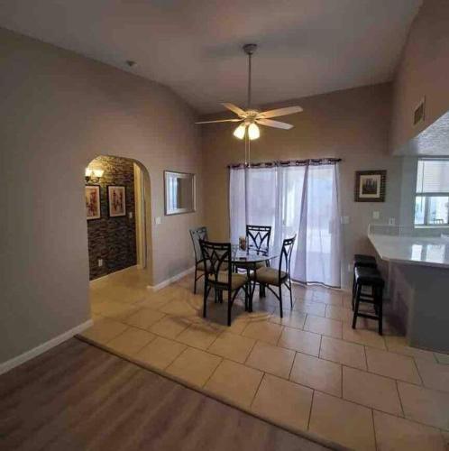a dining room and kitchen with a table and chairs at Lake Havasu Retreat w pool Everything Nearby! in Lake Havasu City