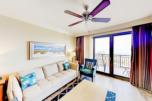 a living room with a couch and a ceiling fan at Emerald Grande in Destin