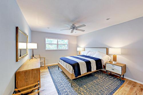 a bedroom with a bed and a ceiling fan at Breezy Ocean Escape in Lake Worth