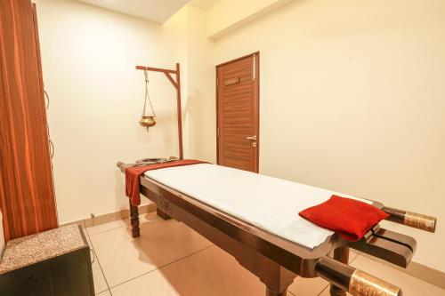 a hospital room with a bed with a red towel on it at Golden Healing Journeys Homestay in Rishīkesh