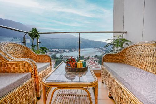 a balcony with a table with a bowl of fruit on it at Golden Healing Journeys Homestay in Rishīkesh