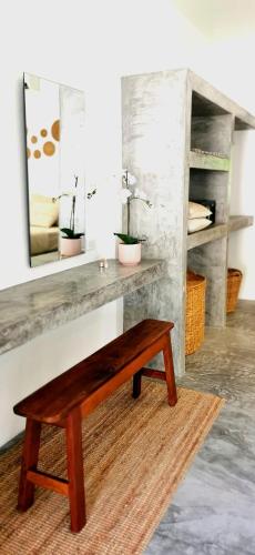 a wooden bench in a room with a mirror at LiLi's Rooms in Ko Lanta