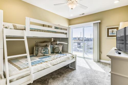 a bedroom with two bunk beds and a window at Bella Sun 201a in Ocean City