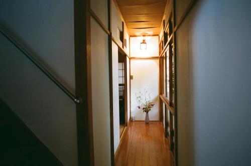 a hallway with a vase of flowers in a room at Hakonowa in Hakone