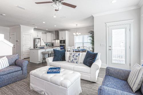 a living room with two couches and a kitchen at Grande Pointe Driftwood in Inlet Beach