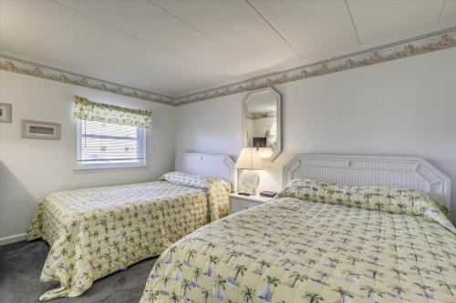 a hotel room with two beds and a window at Diamond Beach II in Ocean City