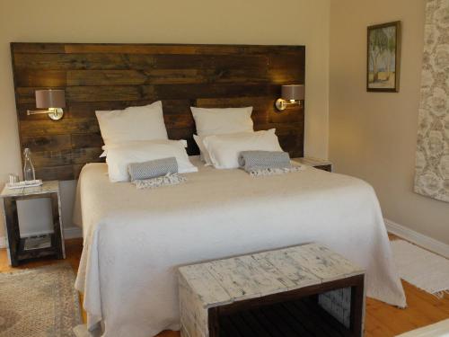 a bedroom with a large bed with a wooden headboard at Doorways in Barrydale