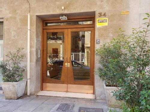 une porte en verre d'un bâtiment avec une voiture à l'intérieur dans l'établissement Masa House, à Palerme
