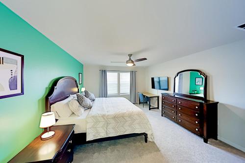 a bedroom with a bed and a dresser and a mirror at Windsor Island Resort 237 in Davenport