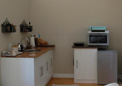 a kitchen with a microwave on top of a counter at Doorways in Barrydale