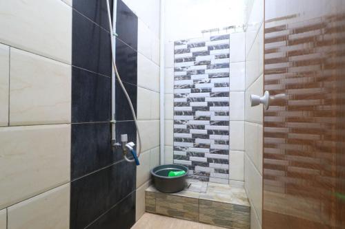 a bathroom with a shower with a toilet in it at Eiffel Residence Tarakan - Female Only in Jakarta