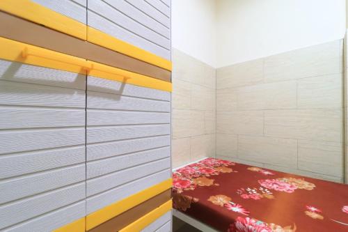 a bedroom with a bed with flowers on it at Eiffel Residence Tarakan - Female Only in Jakarta