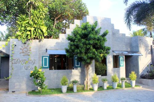 a building with a tree in front of it at Morning Star Resorts in Negombo
