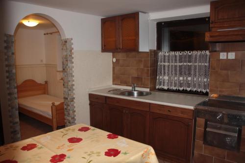 a kitchen with a sink and a counter with a table at Garden Apartments Maria in Bled