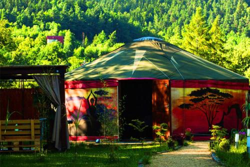 a large tent with a painting on the side of it at Aloha Glamp - Domki z prywatnym jacuzzi & balia & sauna in Zagórnik