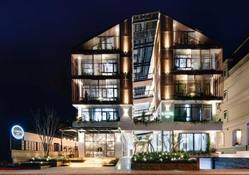 a building with a lit up facade at night at Lasol Boutique Hotel in Da Lat
