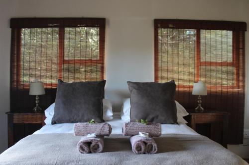 a bedroom with a bed with two stuffed animals on it at Outspan Safaris in Komga