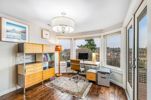 an office with a desk and a computer in a room with windows at Top of Queen Anne in Seattle