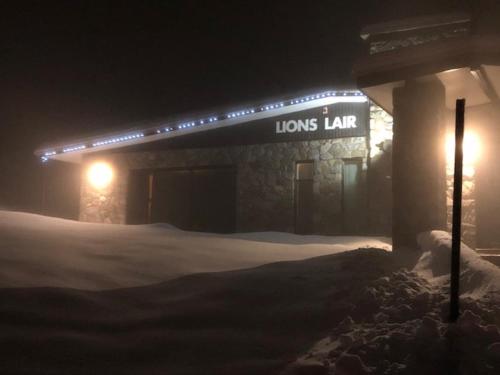 a sign for a louis lars law building at night at The Lions Lair Lodge in Smiggin Holes