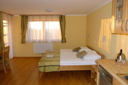 a small room with a bed in a kitchen at Guest House Eco Vila Mila in Rogaška Slatina