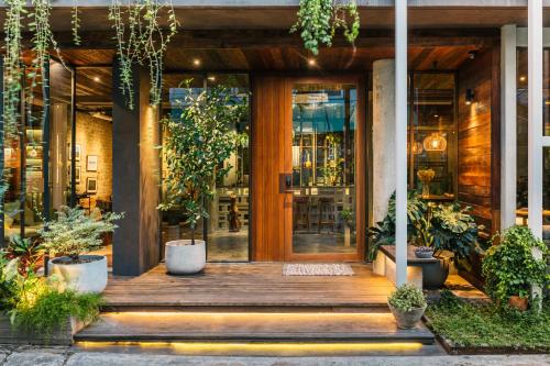 an entrance to a building with potted plants at Tamni in Bangkok