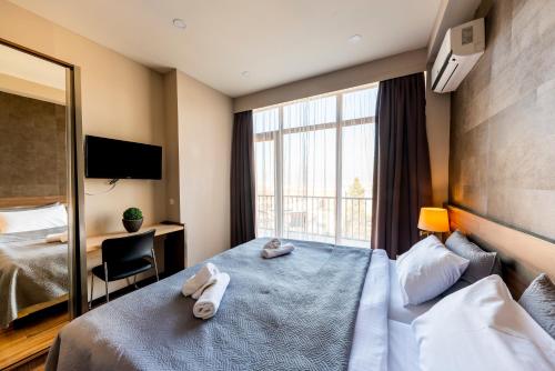 Postel nebo postele na pokoji v ubytování Sani Apart Hotel