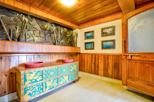 a room with a podium with a screen and a stone wall at Summit Ttakshang Residency Hotel & Spa Mg Marg in Gangtok