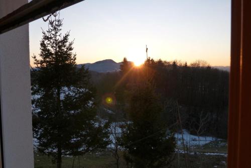 a view of the sunset from a window at Guest House Eco Vila Mila in Rogaška Slatina