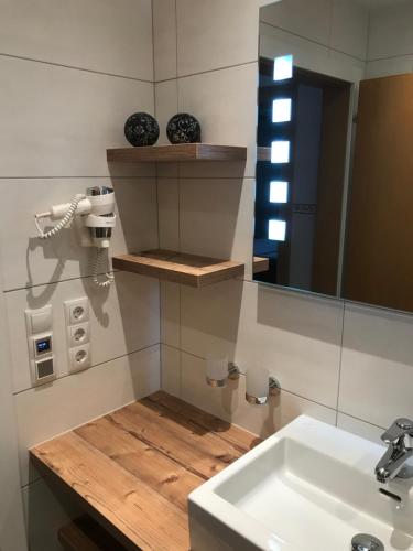 a bathroom with a sink and a mirror at Appartement Höll in Wagrain