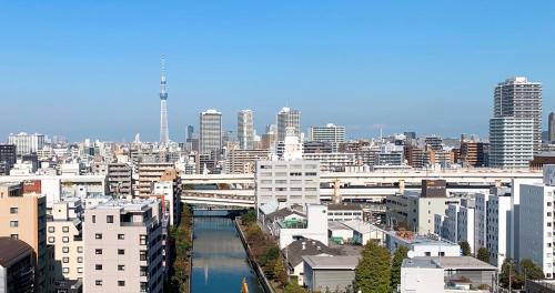 a view of a city with a river and buildings at Day Nice Hotel Tokyo in Tokyo