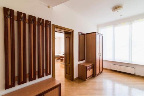 a dressing room with wooden furniture and a large window at Koncha-Zaspa Spa Hotel in Svalyava